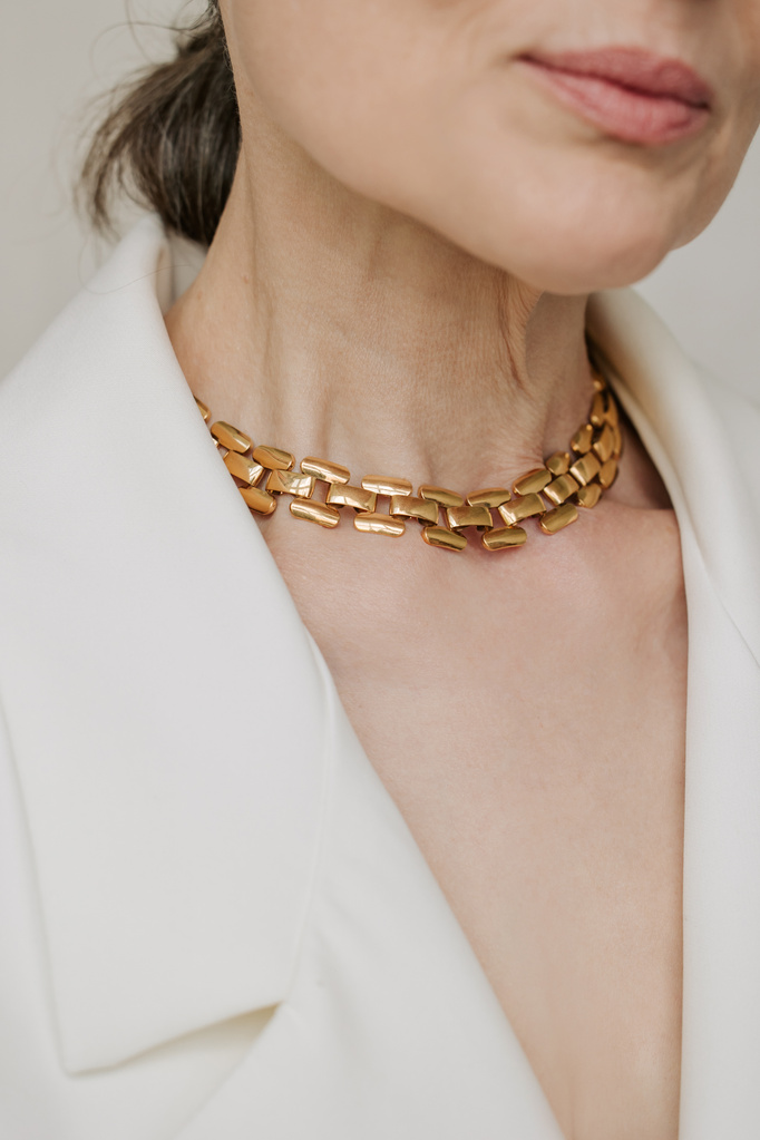 Mature Woman in Blazer and Gold Necklace